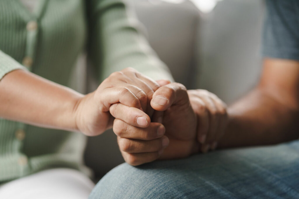 Illustration of two persons holding hands