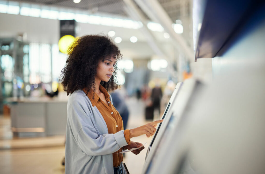 Woman using a Self-Service kiosk